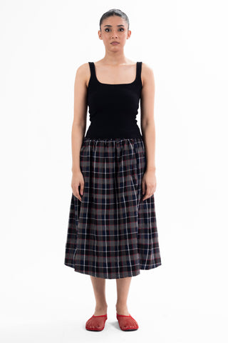 Navy and red check Maze midi skirt from the KKP collection by Naqees, worn — Pakistani streetwear