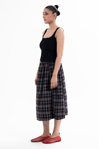 Navy and red check Maze midi skirt from the KKP collection by Naqees, worn — Pakistani streetwear